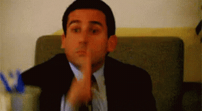 Man In Suit And Tie Shushing GIF