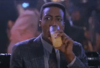 Man In Suit And Tie Sitting At Bar GIF