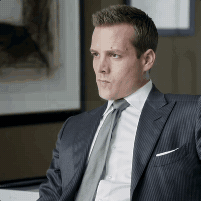 Man In Suit And Tie Sitting At Desk GIF