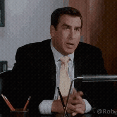 Man In Suit And Tie Sitting At Desk GIF