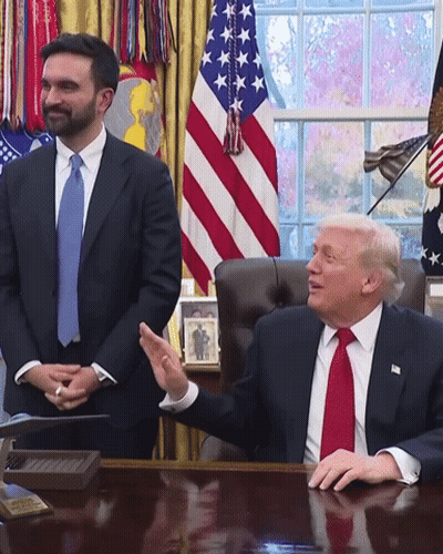 Man In Suit And Tie Sitting At Desk GIF