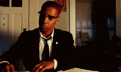 Man In Suit And Tie Sitting At Desk GIF