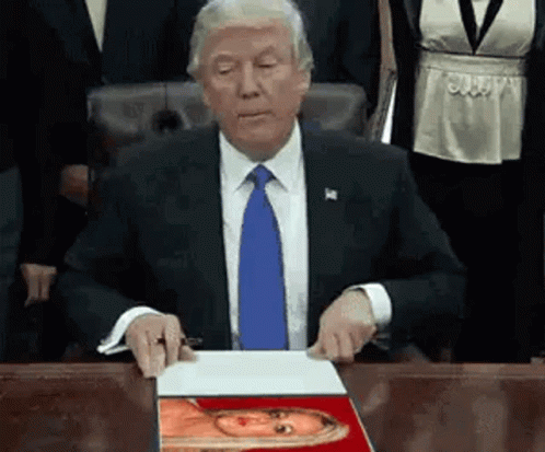 Man In Suit And Tie Sitting At Desk GIF