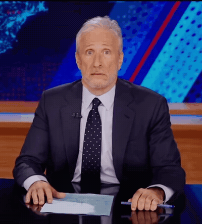 Man In Suit And Tie Sitting At Desk With Hands On Paper GIF