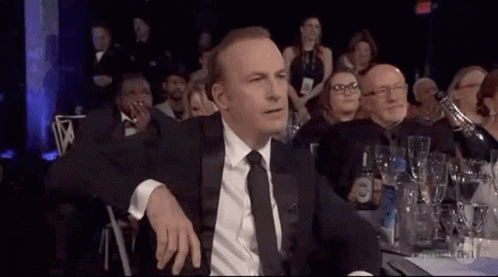 Man In Suit And Tie Sitting At Dinner Table GIF