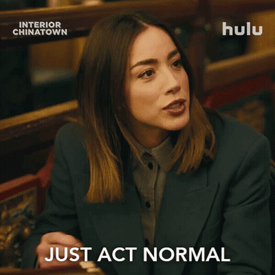 Man In Suit And Tie Sitting At Hulu Ad GIF