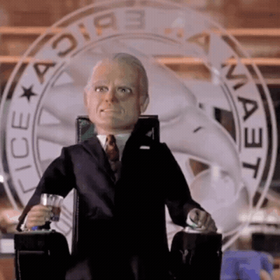 Man In Suit And Tie Sitting At Ice Sign GIF