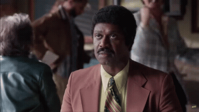 Man In Suit And Tie Sitting At Restaurant Table GIF