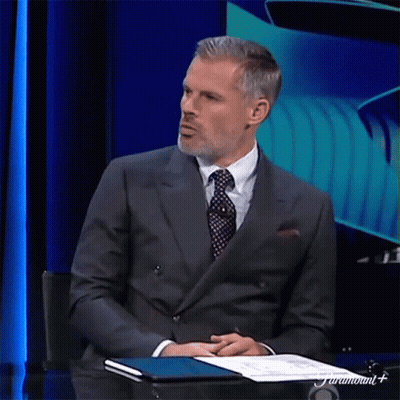 Man In Suit And Tie Sitting At Table GIF