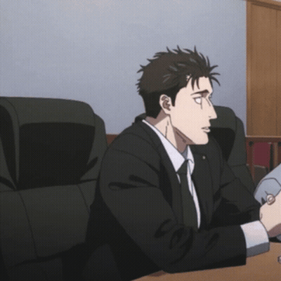 Man In Suit And Tie Sitting At Table GIF
