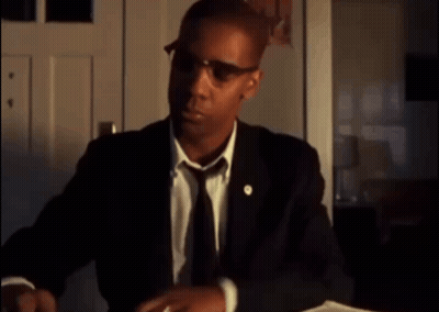 Man In Suit And Tie Sitting At Table GIF