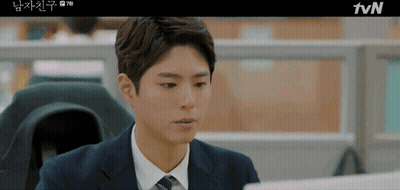 Man In Suit And Tie Sitting At TVN Screen GIF