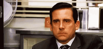 Man In Suit And Tie Sitting By Microwave GIF