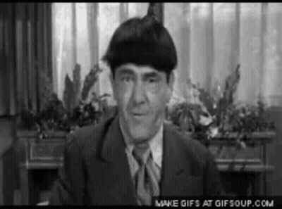 Man In Suit And Tie Sitting By Window GIF