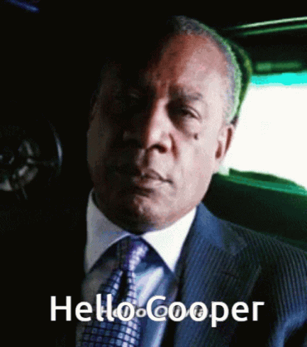 Man In Suit And Tie Sitting In Car Saying Hello Cooper GIF