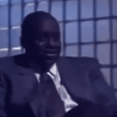 Man In Suit And Tie Sitting In Chair GIF