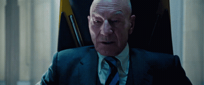 Man In Suit And Tie Sitting In Chair GIF