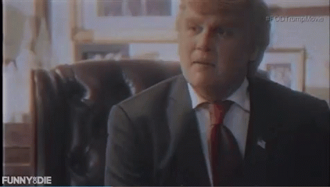Man In Suit And Tie Sitting In Chair Saying Funny Die GIF