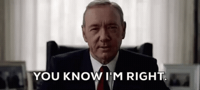 Man In Suit And Tie Sitting In Chair GIF