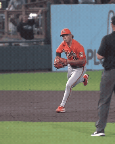 Man In Suit And Tie Sitting In Crowd GIF