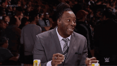 Man In Suit And Tie Sitting In Front Of Screen Saying Wwetlg GIF