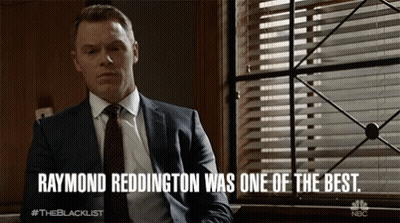 Man In Suit And Tie Sitting In Front Of Window Raymond Reddington Was One Of The Be GIF