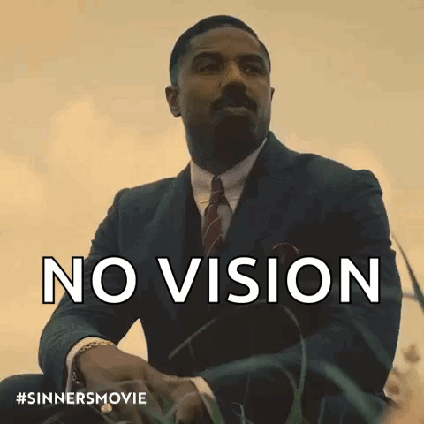 Man In Suit And Tie Sitting In Grass No Vision GIF