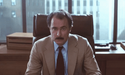 Man In Suit And Tie Sitting In Office Chair GIF