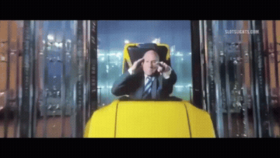 Man in Suit and Tie Sitting in Roller Coaster