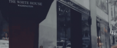 Man In Suit And Tie Sitting In Room GIF