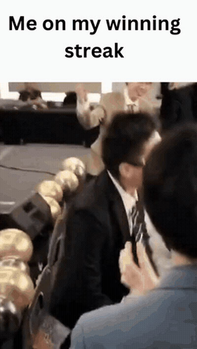 Man In Suit And Tie Sitting In Row Of Chairs GIF