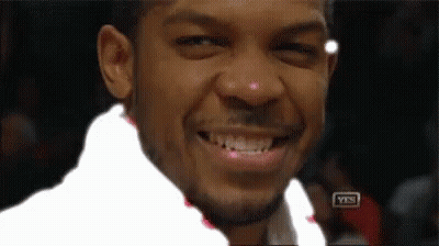 Man In Suit And Tie Sitting In Stadium GIF