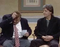Man In Suit And Tie Sitting Next To Another Man GIF