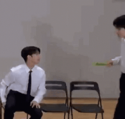 Man In Suit And Tie Sitting Next To Man GIF