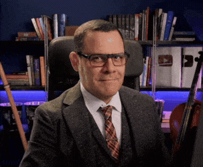 Man In Suit And Tie Sitting GIF