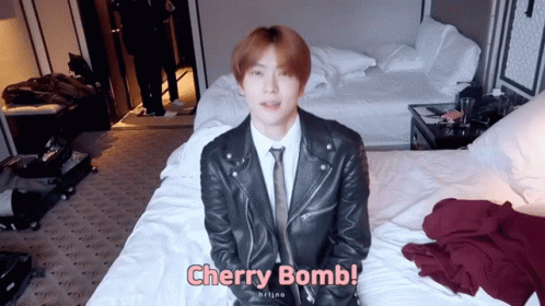Man In Suit And Tie Sitting On Bed Cherry Bomb GIF