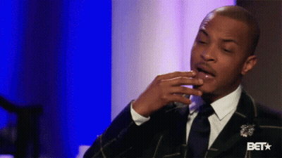 Man In Suit And Tie Sitting On Blue Background GIF