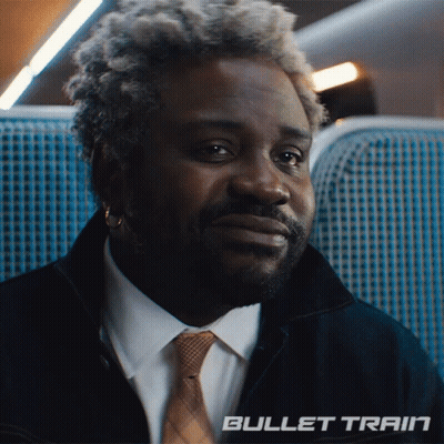 Man In Suit And Tie Sitting On Bullet Train GIF