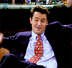 Man In Suit And Tie Sitting On Chair GIF