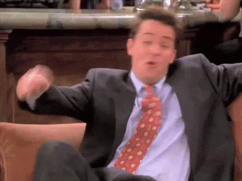 Man In Suit And Tie Sitting On Chair GIF