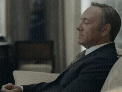 Man In Suit And Tie Sitting On Couch GIF