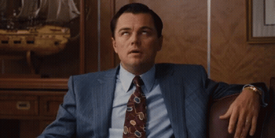 Man In Suit And Tie Sitting On Couch GIF
