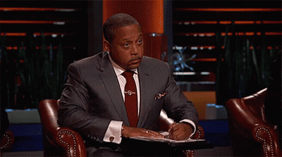 Man In Suit And Tie Sitting On Show GIF