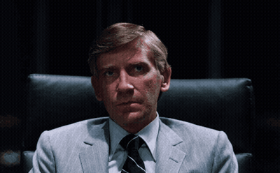 Man In Suit And Tie Sitting With Hands Folded GIF