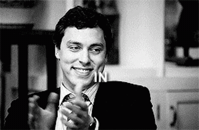 Man In Suit And Tie Smiling And Clapping GIF