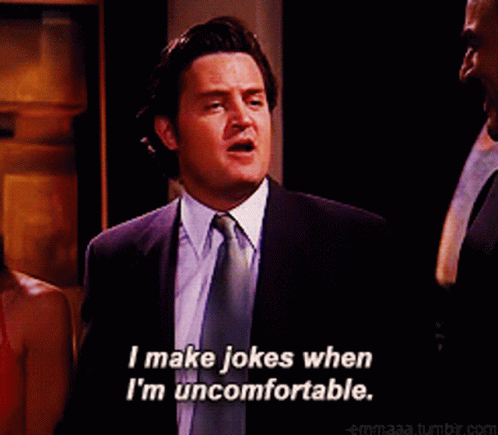 Man In Suit And Tie Smiling And Saying I Make Jokes When I'm Uncomfortable GIF