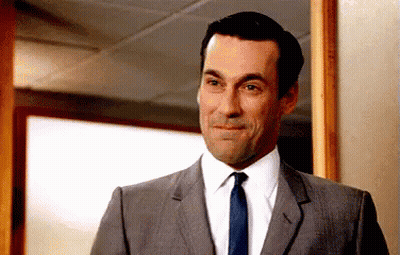 Man In Suit And Tie Smiling At Camera GIF