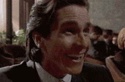 Man In Suit And Tie Smiling At Camera GIF