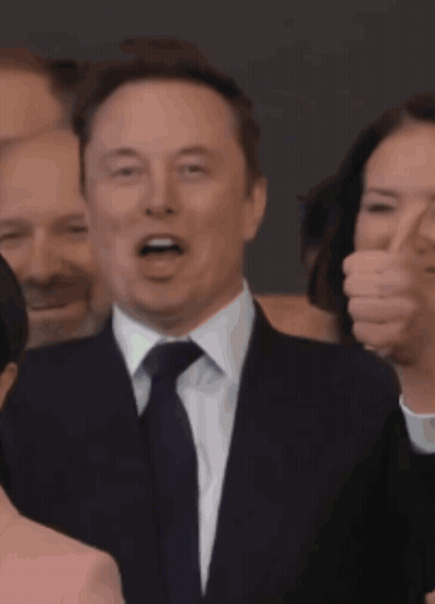 Man In Suit And Tie Smiling At Crowd GIF