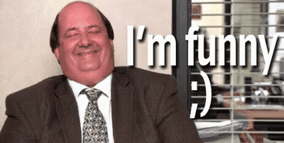Man In Suit And Tie Smiling At Desk GIF